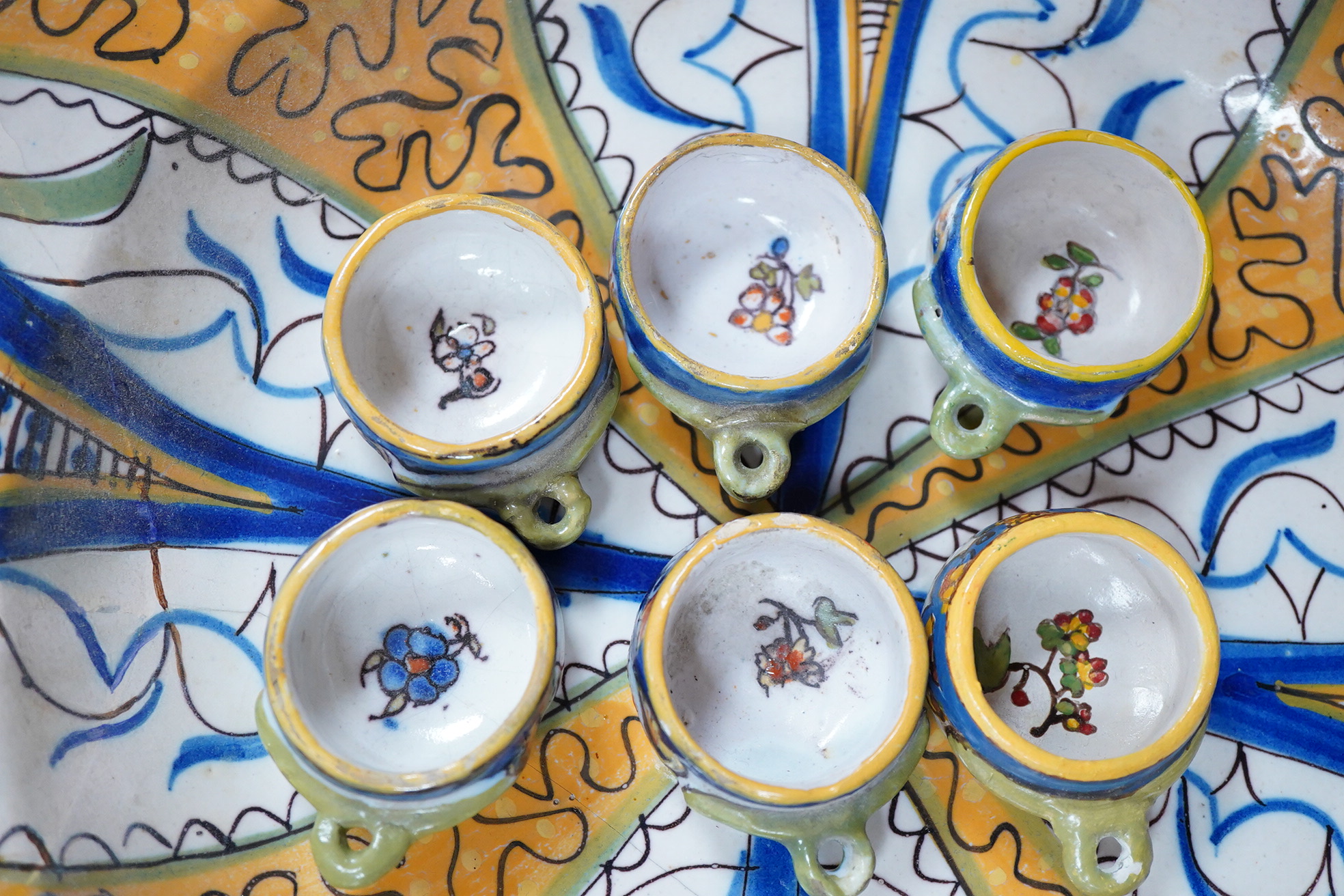 Two 18th century Delft polychrome chargers, five other faience chargers, a rectangular 19th century French faience dish and a blue and white letter rack